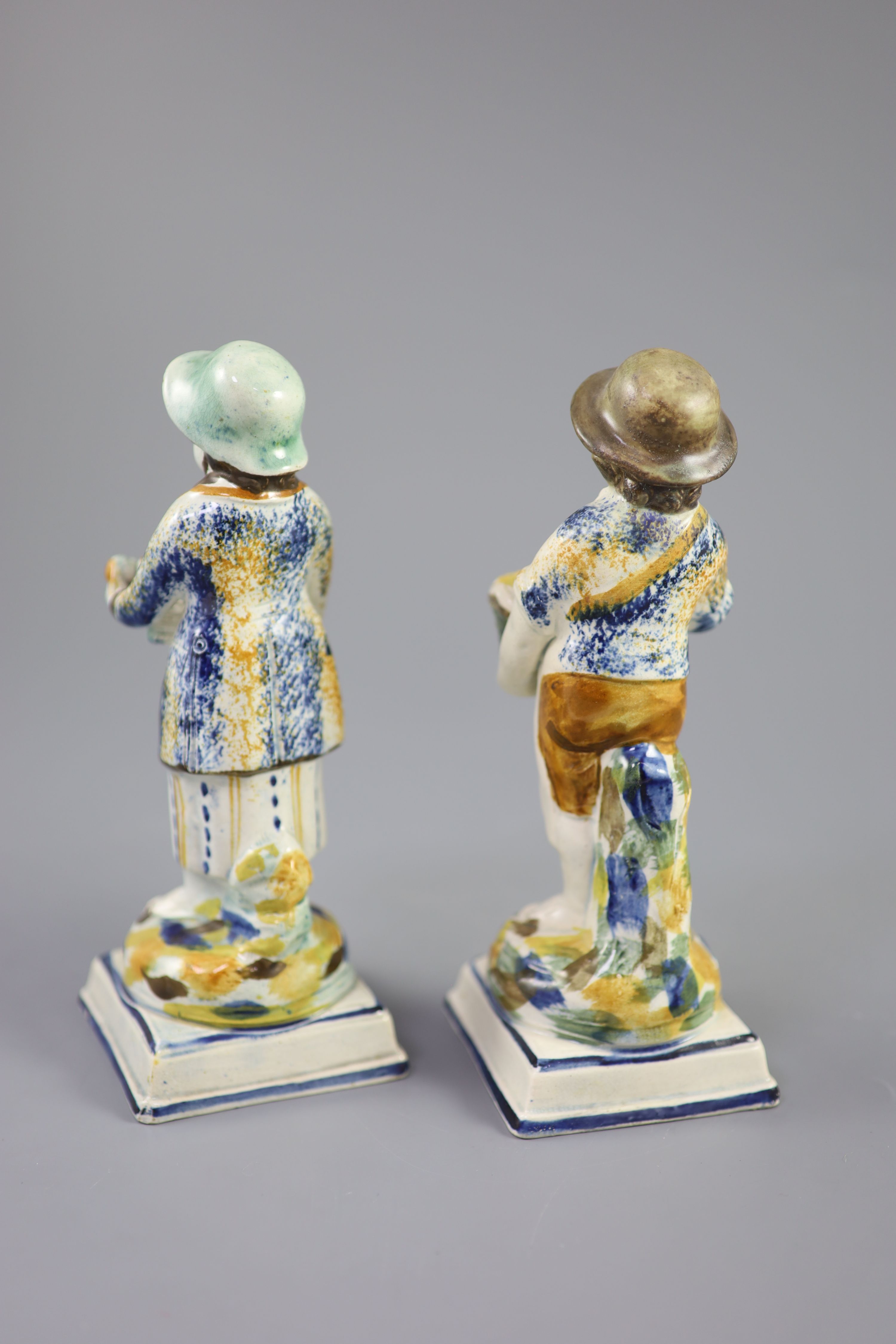 A pair of Prattware figures of fruit and biscuit street vendors, c.1790-1800, 17.5cm high